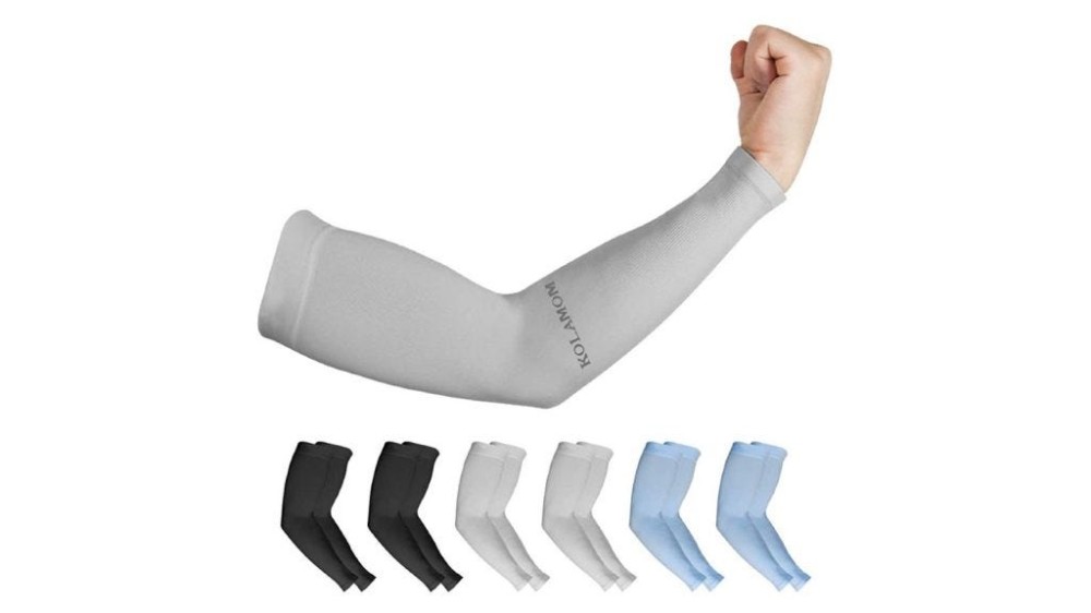 six colorful compression arm sleeves with one gray compression arm sleeve on an arm