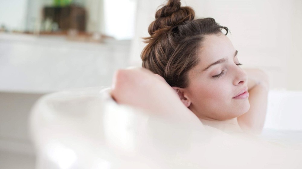 A woman taking a bath in Epsom salts.