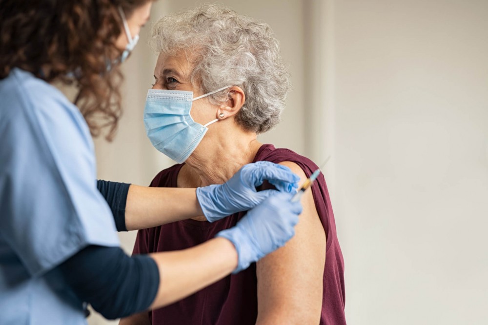 Older woman receiving COVID-19 vaccine